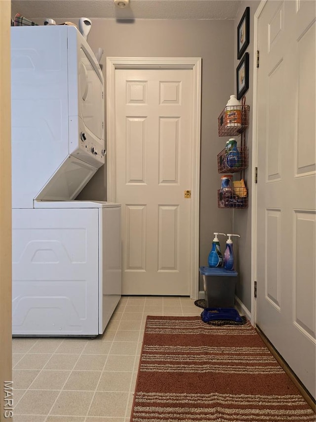 310 E 1st St, Ramsey, IL 62080 - laundry area featuring stacked washer / dryer and light tile patterned floors