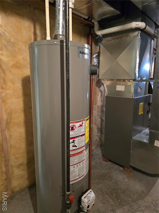 310 E 1st St, Ramsey, IL 62080 - utility room featuring water heater and heating unit