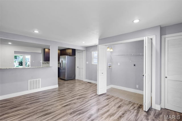 7104 Leona St, Saint Louis, MO 63116 - unfurnished living room featuring wood finished floors and recessed lighting