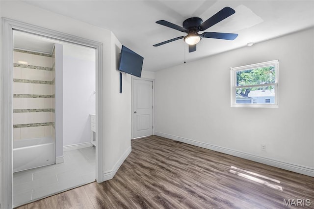 7104 Leona St, Saint Louis, MO 63116 - unfurnished bedroom with wood finished floors and ceiling fan