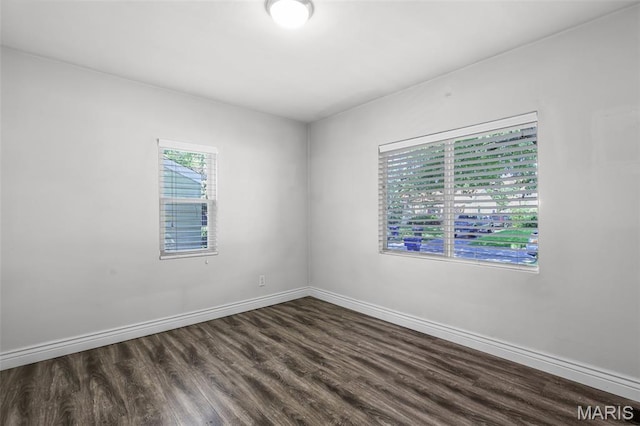 7104 Leona St, Saint Louis, MO 63116 - spare room featuring dark wood-style flooring and baseboards