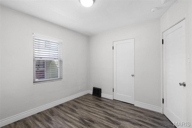 7104 Leona St, Saint Louis, MO 63116 - unfurnished bedroom featuring dark wood-style flooring
