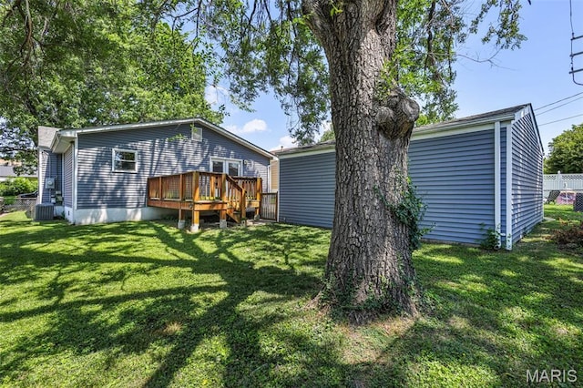 7104 Leona St, Saint Louis, MO 63116 - rear view of house with a wooden deck and a lawn
