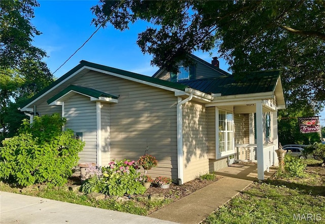 4846 S Point Rd, Washington, MO 63090 - view of home's exterior featuring a metal roof and a chimney