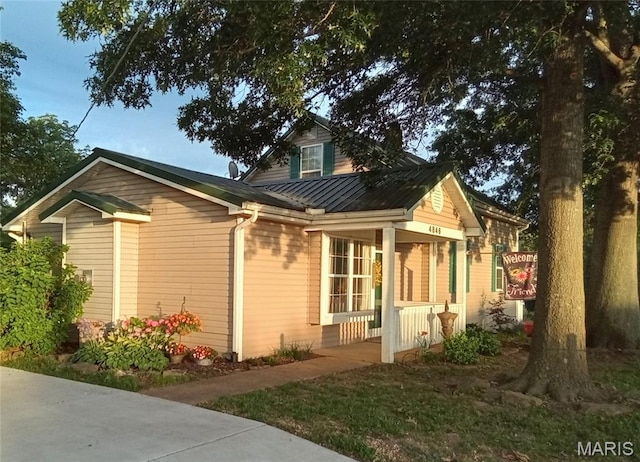 4846 S Point Rd, Washington, MO 63090 - view of side of home with covered porch, a metal roof, and a standing seam roof