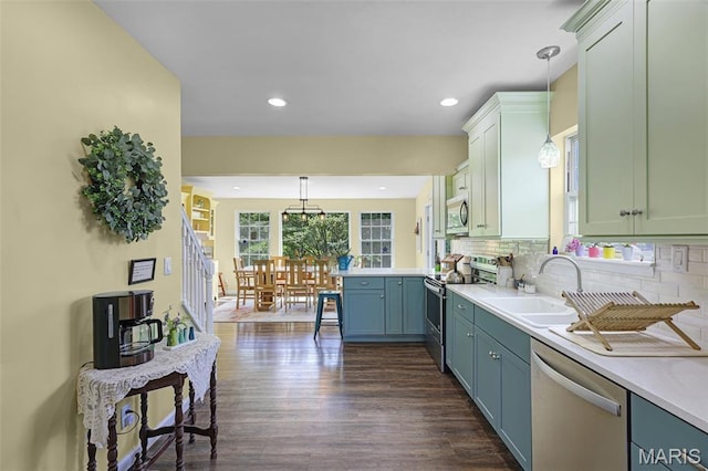 4846 S Point Rd, Washington, MO 63090 - kitchen with appliances with stainless steel finishes, light countertops, dark wood-style flooring, decorative light fixtures, and recessed lighting