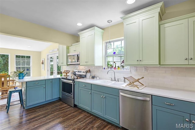 4846 S Point Rd, Washington, MO 63090 - kitchen featuring stainless steel appliances, a peninsula, light countertops, tasteful backsplash, and healthy amount of natural light