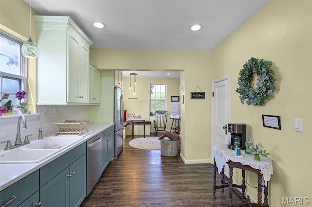 4846 S Point Rd, Washington, MO 63090 - kitchen with appliances with stainless steel finishes, dark wood finished floors, light countertops, tasteful backsplash, and decorative light fixtures