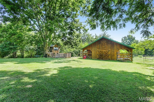 4846 S Point Rd, Washington, MO 63090 - view of yard with an outdoor structure, a deck, and view of wooded area