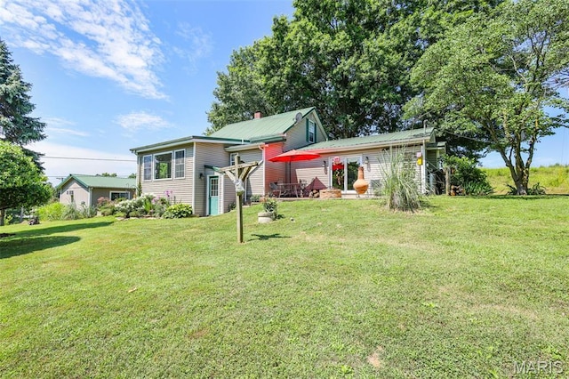 4846 S Point Rd, Washington, MO 63090 - back of house featuring a yard and a metal roof