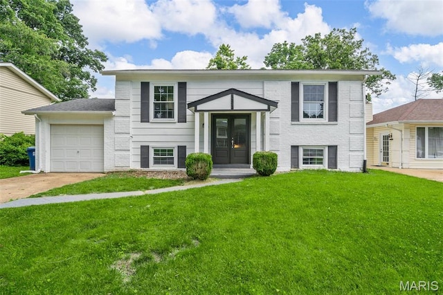 383 Messina Dr, Ballwin, MO 63021 - bi-level home featuring a front lawn, concrete driveway, a garage, and brick siding