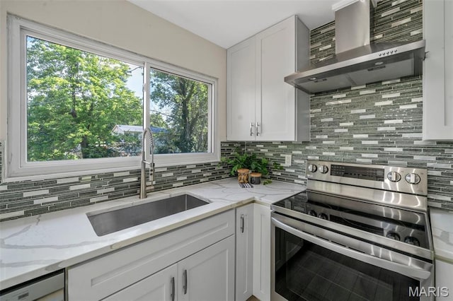 383 Messina Dr, Ballwin, MO 63021 - kitchen featuring stainless steel electric range oven, wall chimney range hood, decorative backsplash, and white cabinetry