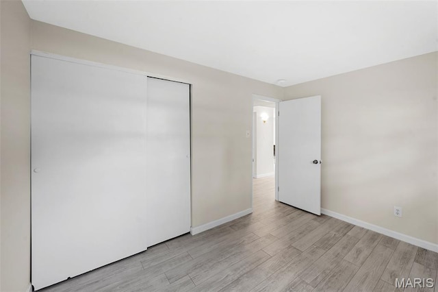 383 Messina Dr, Ballwin, MO 63021 - unfurnished bedroom with light wood-style floors and a closet