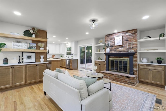 246 Leichester Cir, Ballwin, MO 63011 - living room with light wood-style flooring, a fireplace, and recessed lighting