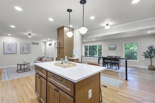 246 Leichester Cir, Ballwin, MO 63011 - kitchen with open floor plan, a center island, light wood-type flooring, light countertops, and recessed lighting