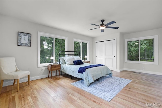 246 Leichester Cir, Ballwin, MO 63011 - bedroom with light wood-style flooring, a closet, and a ceiling fan