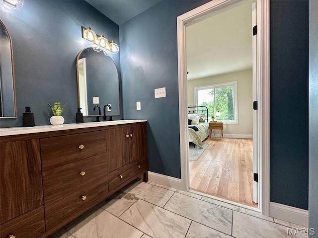246 Leichester Cir, Ballwin, MO 63011 - bathroom featuring vanity, marble look tiles, and ensuite bathroom
