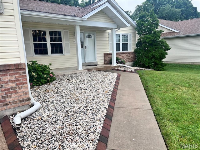 1 Calumet Meadows Ct, Ofallon, MO 63376 - entrance to property with brick siding, covered porch, and a lawn