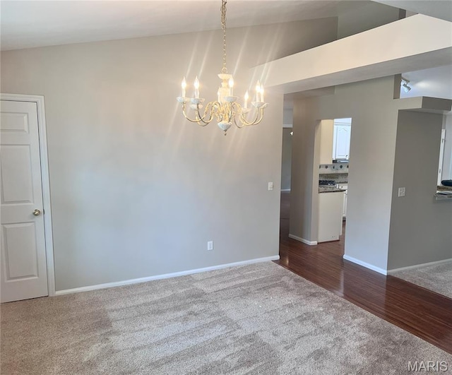 1 Calumet Meadows Ct, Ofallon, MO 63376 - unfurnished room featuring dark carpet and a chandelier