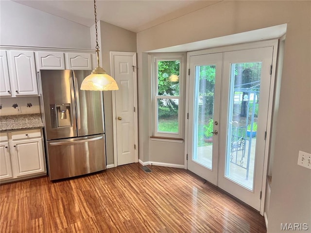 1 Calumet Meadows Ct, Ofallon, MO 63376 - kitchen with stainless steel fridge, french doors, light wood finished floors, plenty of natural light, and lofted ceiling