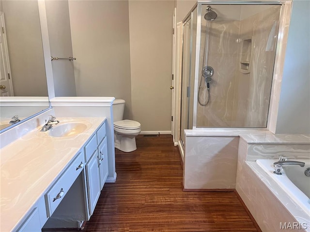 1 Calumet Meadows Ct, Ofallon, MO 63376 - bathroom with wood finished floors, vanity, a shower stall, and a garden tub