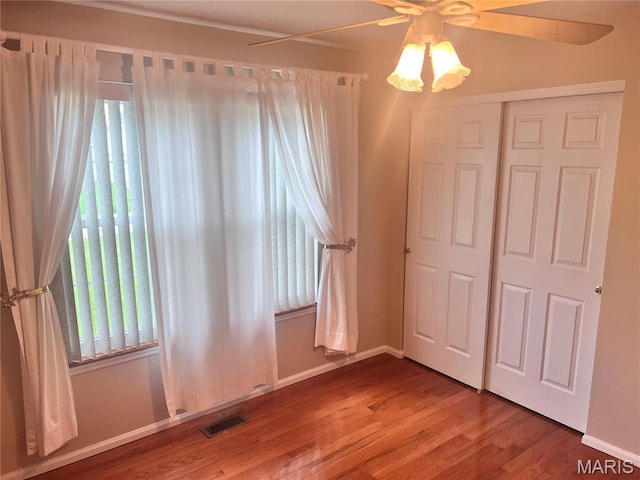 1 Calumet Meadows Ct, Ofallon, MO 63376 - unfurnished bedroom with wood finished floors, a closet, and a ceiling fan