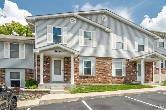2266 Highland Hill Dr Unit F, Saint Peters, MO 63376 - view of property featuring brick siding and uncovered parking