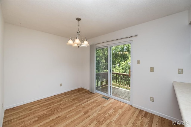 2266 Highland Hill Dr Unit F, Saint Peters, MO 63376 - spare room featuring light wood-type flooring and a chandelier