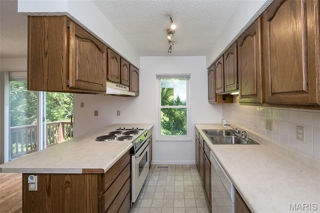 2266 Highland Hill Dr Unit F, Saint Peters, MO 63376 - kitchen featuring white appliances, a textured ceiling, light countertops, tasteful backsplash, and track lighting