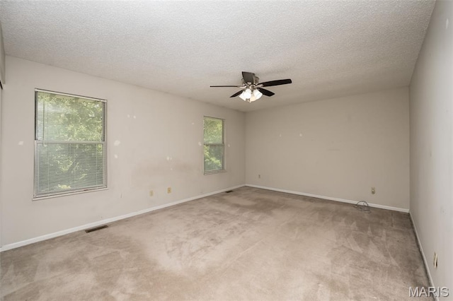 2266 Highland Hill Dr Unit F, Saint Peters, MO 63376 - empty room with healthy amount of natural light, ceiling fan, light carpet, and a textured ceiling