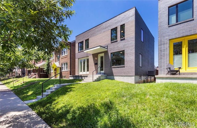 4133 Lafayette Ave, Saint Louis, MO 63110 - view of front of property featuring a front yard and brick siding