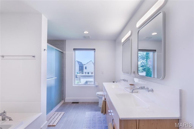 4133 Lafayette Ave, Saint Louis, MO 63110 - bathroom with healthy amount of natural light, double vanity, wood finished floors, a shower with shower door, and recessed lighting