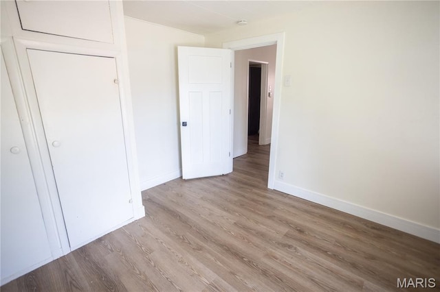7353 Virginia Ave, Saint Louis, MO 63111 - unfurnished bedroom featuring baseboards and light wood-style flooring