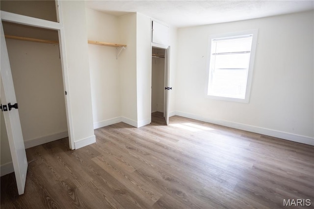7353 Virginia Ave, Saint Louis, MO 63111 - unfurnished bedroom with wood finished floors and baseboards