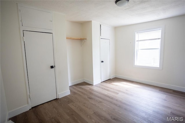 7353 Virginia Ave, Saint Louis, MO 63111 - unfurnished bedroom with a textured ceiling, wood finished floors, and a closet