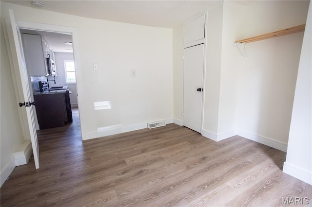 7353 Virginia Ave, Saint Louis, MO 63111 - unfurnished room with wood finished floors and a smoke detector