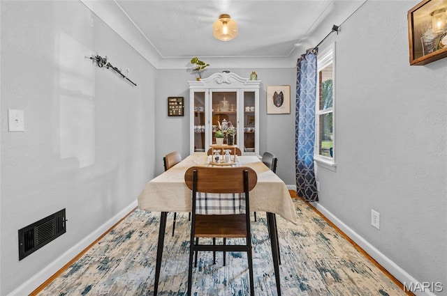 dining room featuring baseboards and wood finished floors