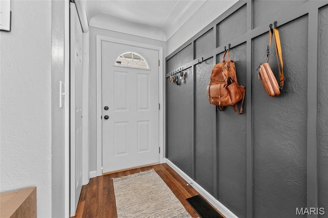 mudroom featuring wood finished floors and baseboards