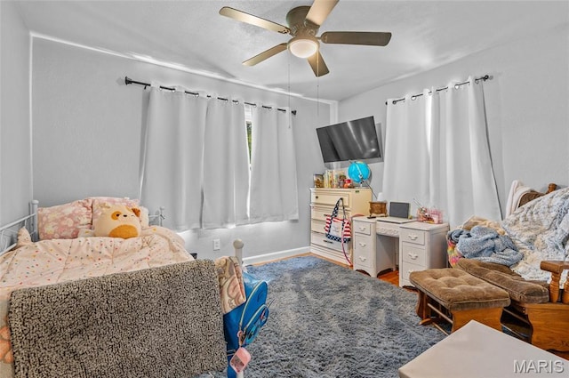 bedroom featuring ceiling fan and baseboards