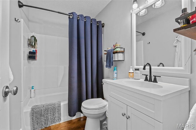 full bathroom featuring shower / bath combo, a textured ceiling, vanity, and wood finished floors