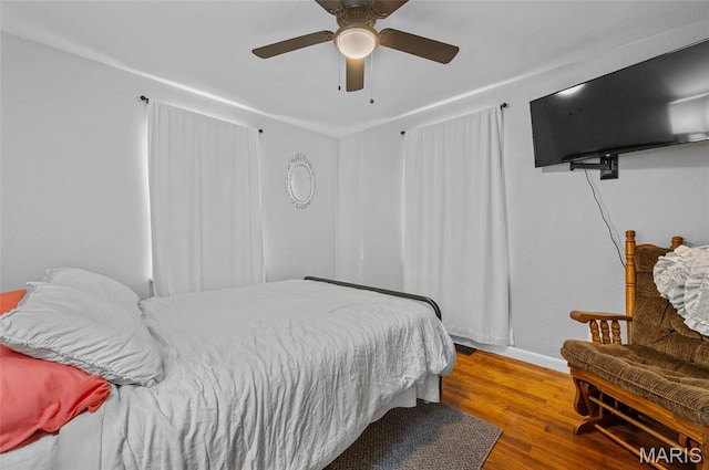 bedroom featuring wood finished floors and a ceiling fan