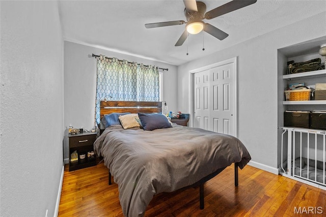 bedroom with wood-type flooring, a closet, and a ceiling fan