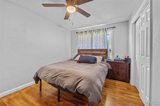 bedroom with light wood finished floors, a closet, and a ceiling fan