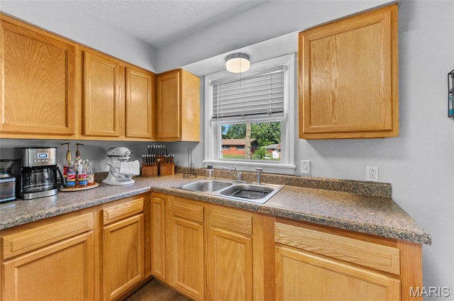 kitchen with a sink and a textured ceiling