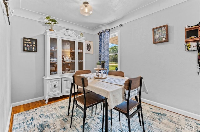 dining area with wood finished floors and baseboards