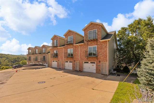 319 Timber Ridge Dr, Grafton, IL 62037 - view of front facade with an attached garage, driveway, and brick siding