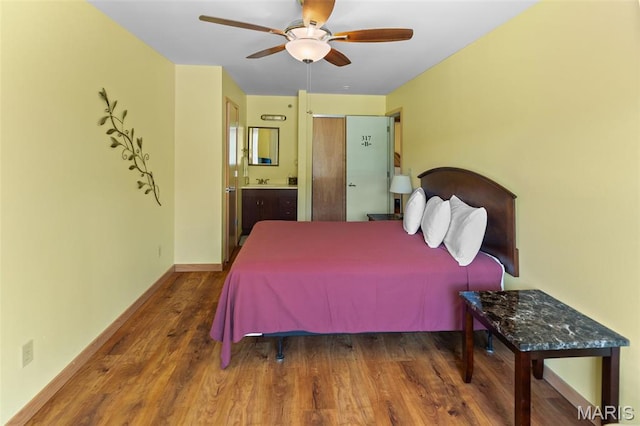 319 Timber Ridge Dr, Grafton, IL 62037 - bedroom with wood finished floors, connected bathroom, and a ceiling fan