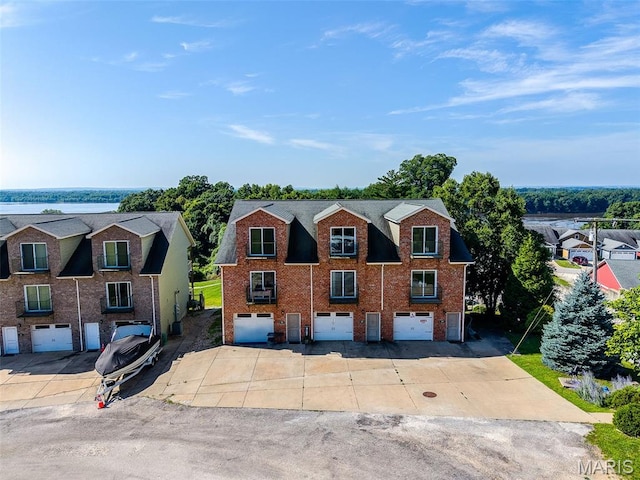319 Timber Ridge Dr, Grafton, IL 62037 - view of front of home featuring an attached garage, brick siding, and driveway