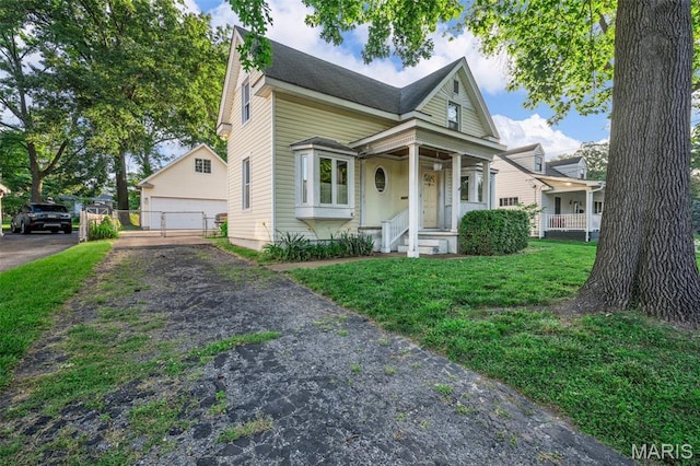 135 Oak Tree Dr, Webster Groves, MO 63119 - view of front of home with a detached garage, an outbuilding, and covered porch
