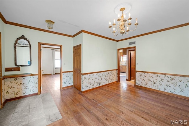 135 Oak Tree Dr, Webster Groves, MO 63119 - spare room featuring a chandelier, wood finished floors, crown molding, plenty of natural light, and a wainscoted wall